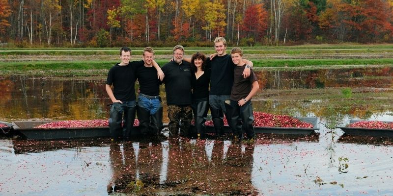 family standing in cranberry bog