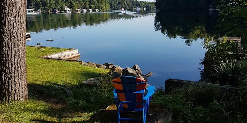 muskoka chair looking down the river