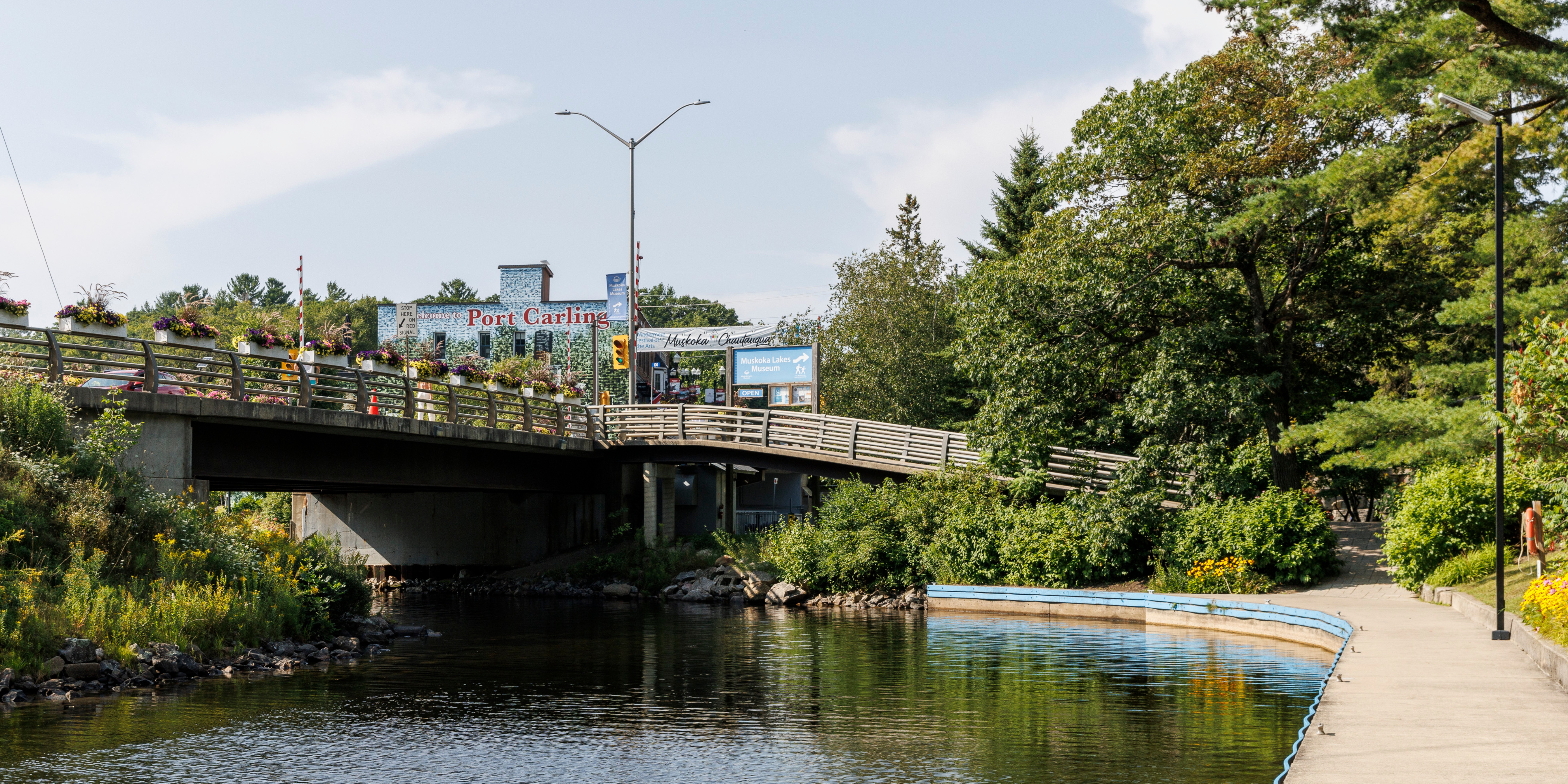 Bridge, deck and lake next to famous Port Carling wall