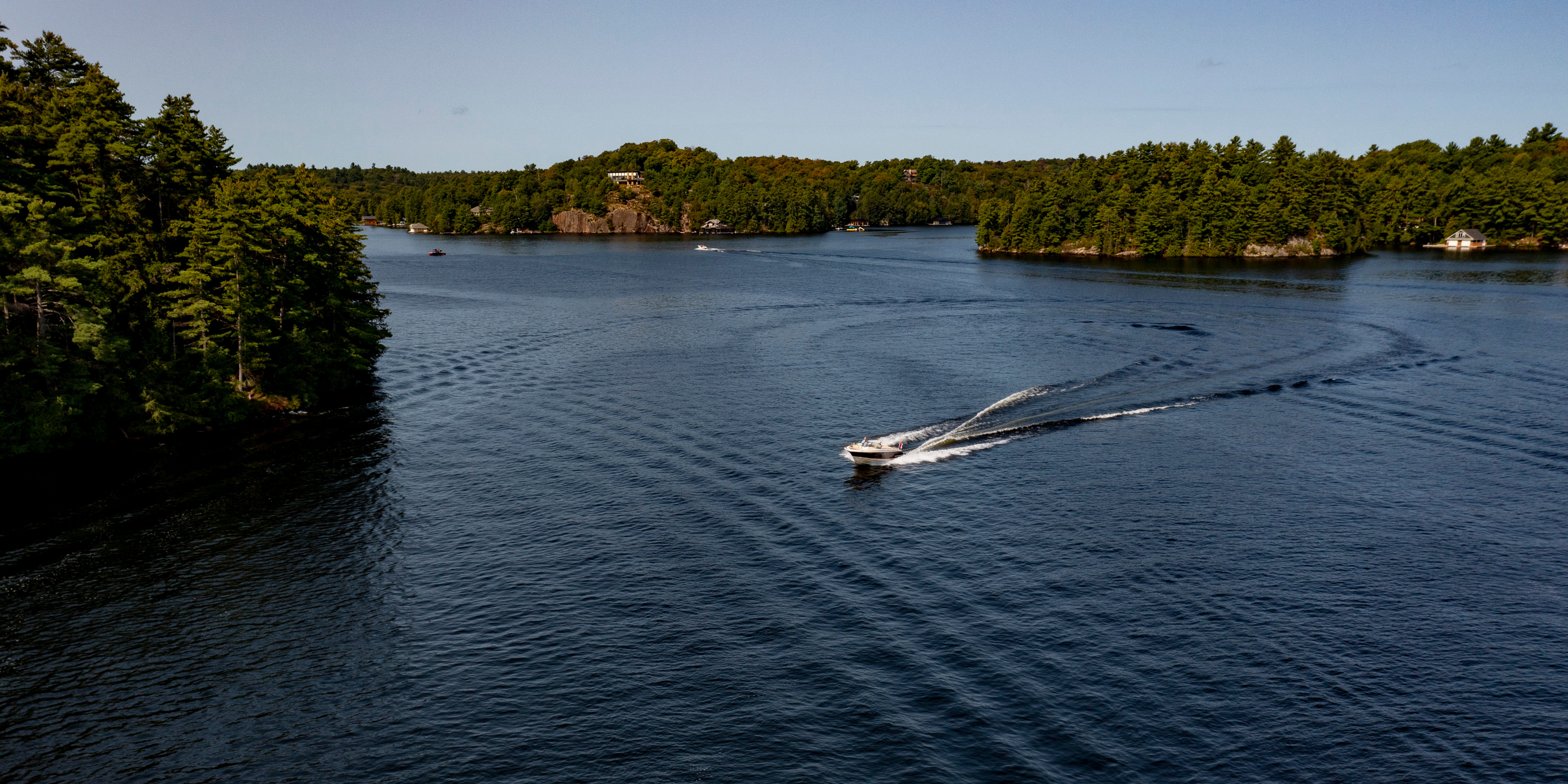 Aerial view of a boat driving on lake