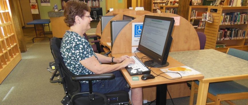 women in wheelchair at accessible computer
