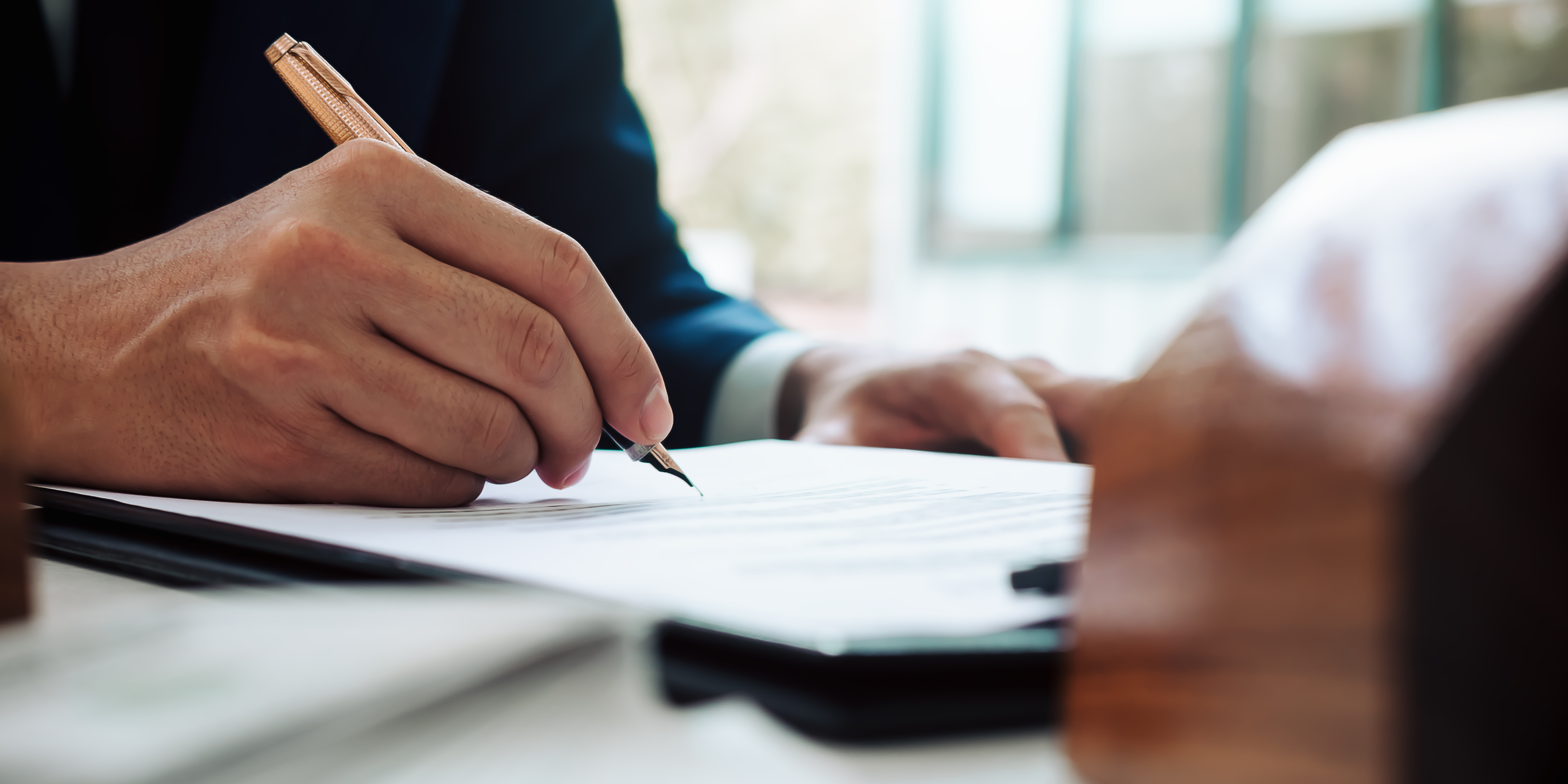 Person signing a paper