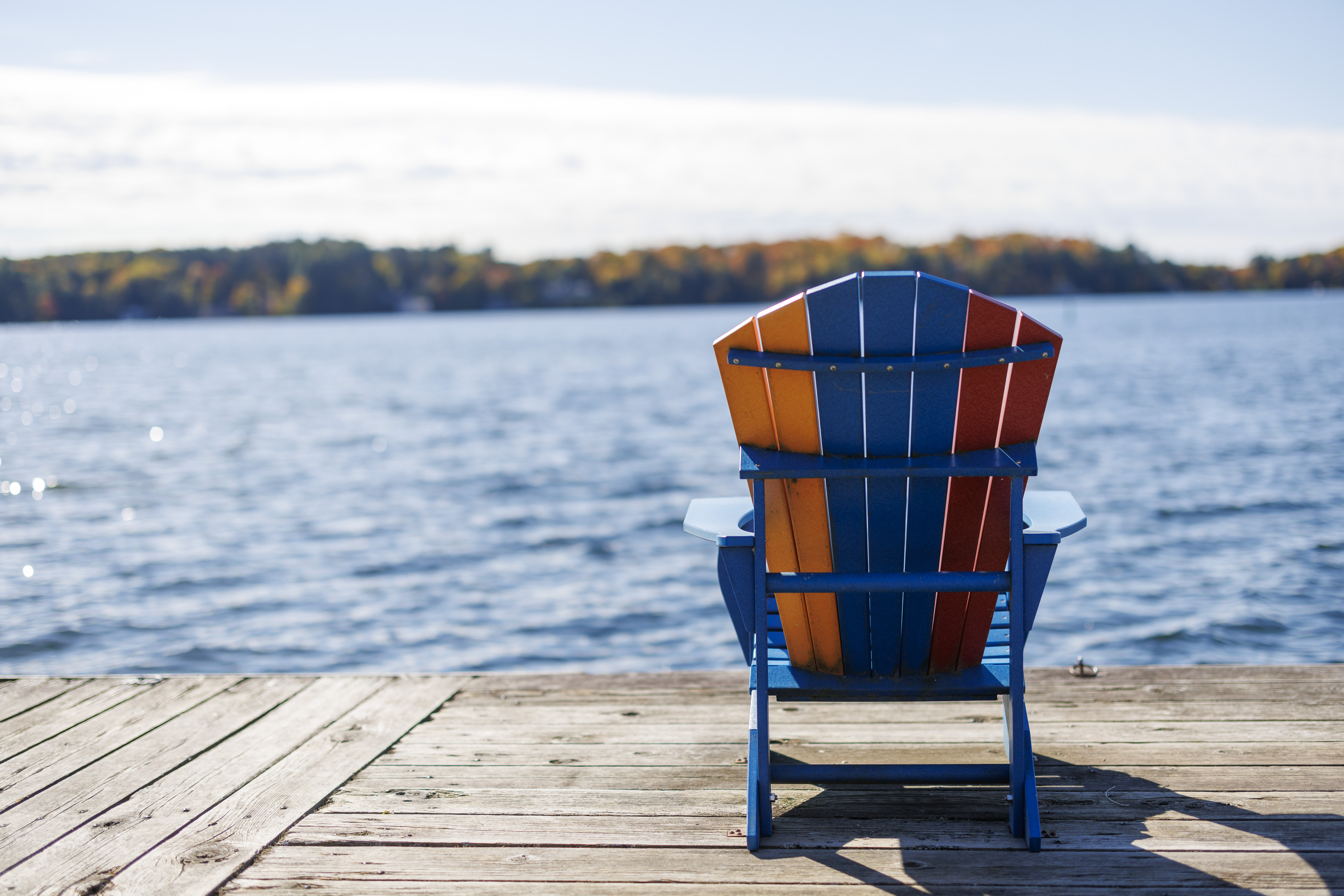 Muskoka Chair facing lake on a dock