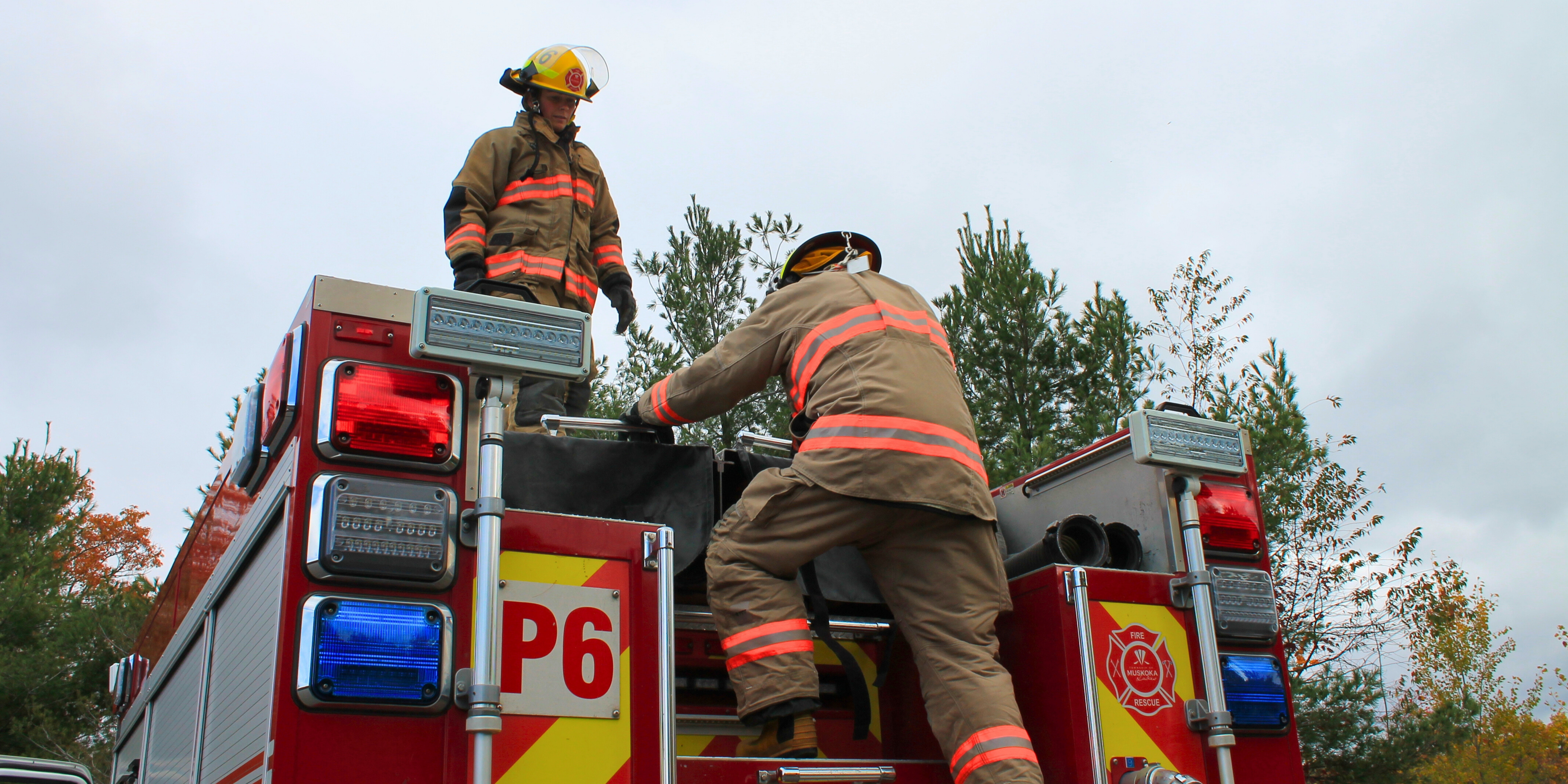 Two firefighters on a fire truck
