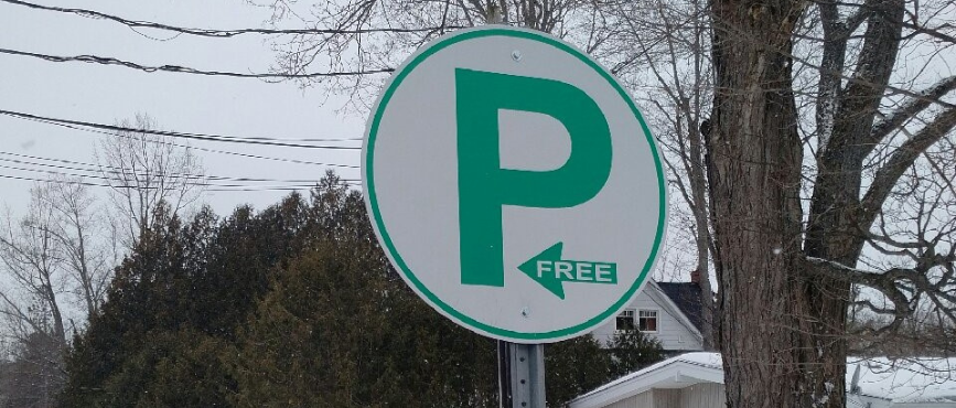 A Free Parking sign indicating the lot is to the left