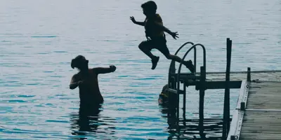 kid jumping off dock
