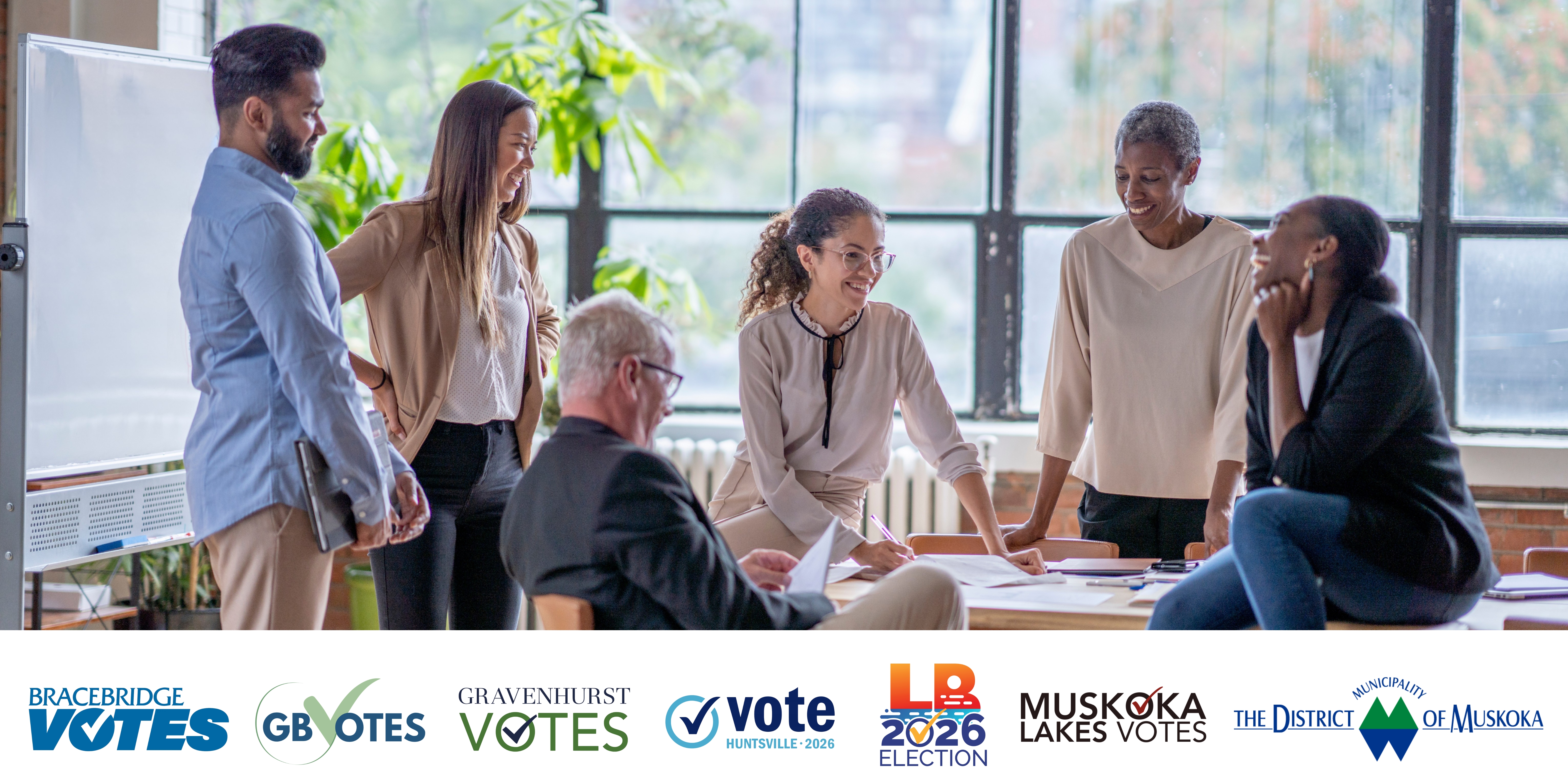 people sitting around a table with all of the local municipality logos underneath
