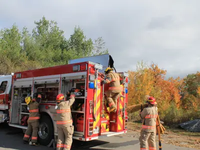 Volunteer firefighters working on a fire truck