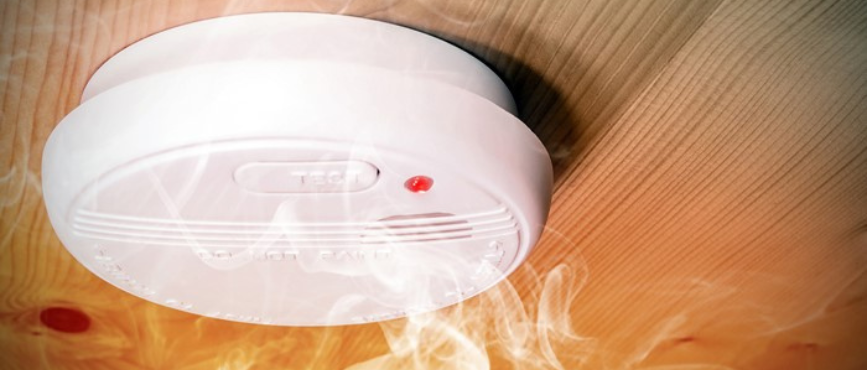 Smoke detector alarm with a whisp of smoke