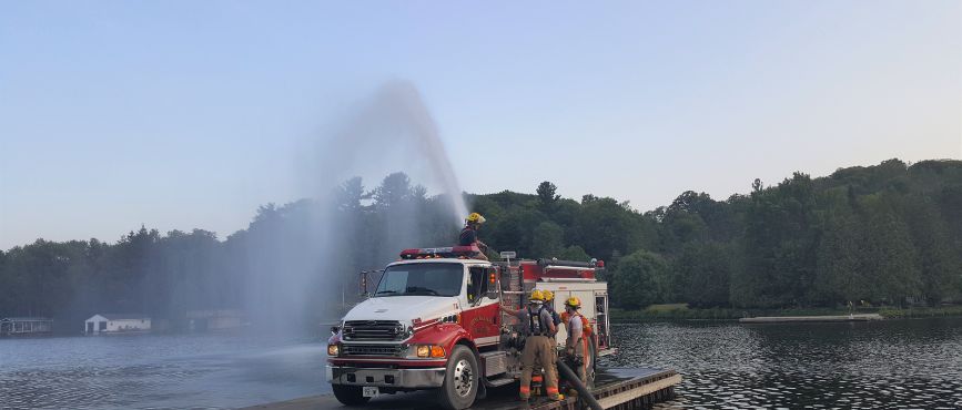 Muskoka Lakes Fire Tanker Truck on a Dock Spraying Water